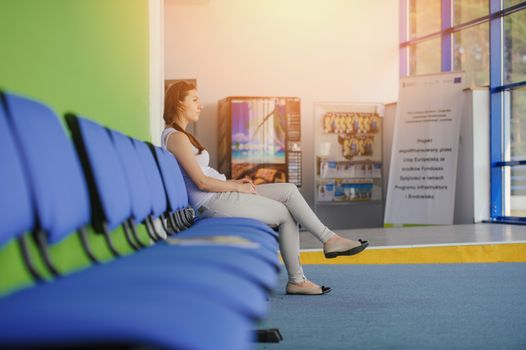 young brunette girl waiting at the airport