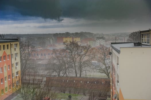 Heavy rain in the city with dramatic dark clouds