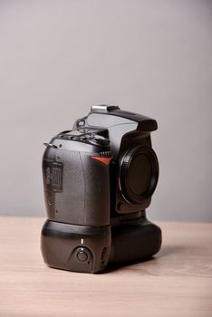 Digital photo camera on wooden desk table