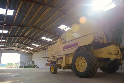 combine harvester standing ready for harvest in a warehouse