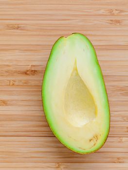 Fresh avocado on wooden background. Organic avocado healthy food concept. Avocado on Bamboo cutting board.The avocado is popular in vegetarian cuisine and weight control.