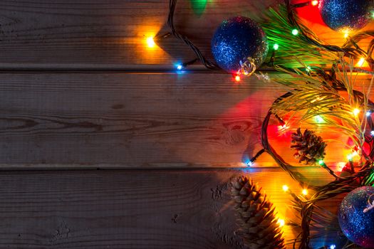 garland and Christmas tree branches on wooden table mock up