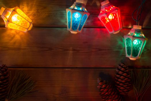 garland and Christmas tree branches on wooden table mock up