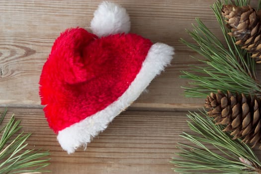 red Santa Claus cap on wooden table
