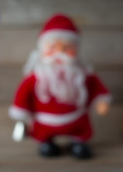 Santa Claus doll with candlee blur background
