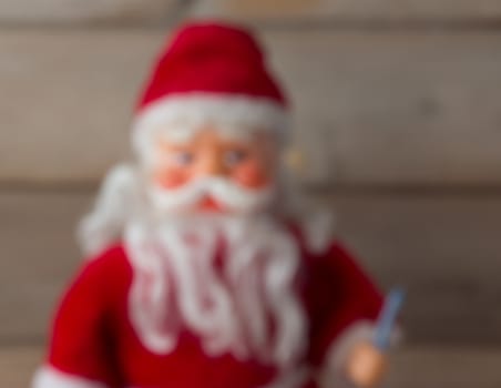 Santa Claus doll with candlee blur background