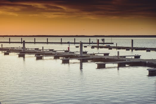 Yacht port over beautiful orange sunset in summer time
