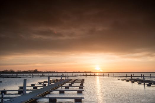 Yacht port over beautiful orange sunset in summer time