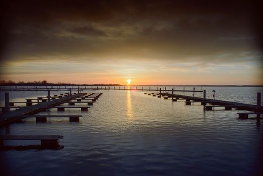 Yacht port over beautiful orange sunset in summer time