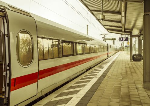 Modern high-speed train with opened door, parked in a german train station