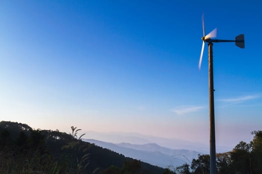 Wind turbine on mountain at sunrise