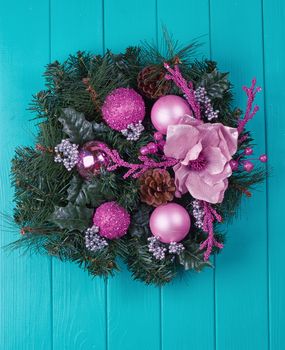 Christmas wreath on a rustic blue wooden front door.