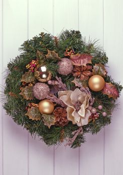 Christmas wreath on a rustic wooden white front door.
