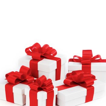 Boxes with presents wrapped in white paper with red ribbons, isolated on white