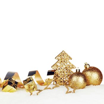 Beautiful various golden christmas decor on snow close-up