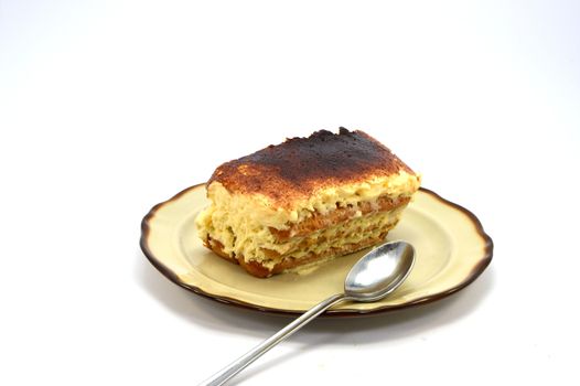tiramisu share on a brown plate on white background