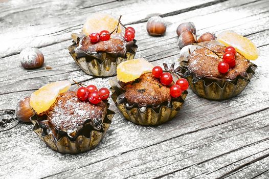 Christmas cupcakes decorated with mandarin and cranberries in an iron-Cup muffin pan