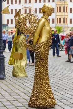 DRESDEN, GERMANY - JULY 13, 2015: a performer - Golden painted artists on a city street, living statues