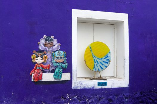 PENANG, MALAYSIA - APRIL 18, 2016: Colorful street art painting of three Chinese dolls in George Town, Penang, Malaysia.