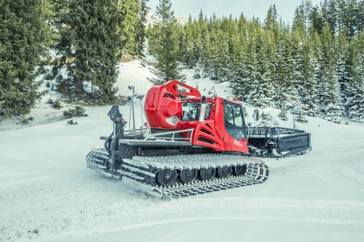 Winter image with a modern snow groomer machine, captured in the Austrian Alps, near the village Ehrwald, district Reutte in Tirol