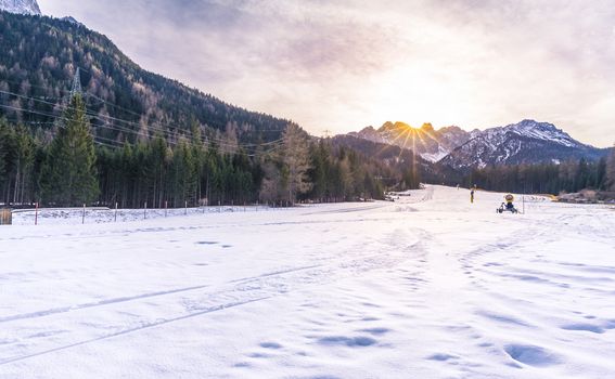 Winter scenery with a ski slope ready to be used, in the Austrian Alps mountains, on a sunny day of December.