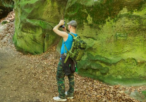 Photographed August 18, 2016 Olšina Czech Republic photographing man standing in nature with rocks