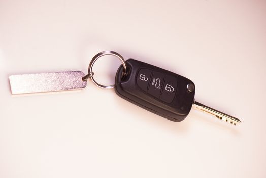 Car keys and drivers license on white background, France