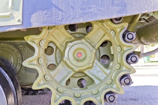 Caterpillar wheel of military machine at the exhibition under open sky