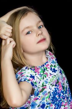 Cute girl are dancing in blue dress on black background