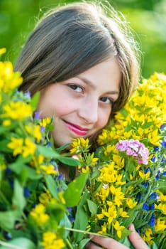 Portrait of a girl with flowers in the garden