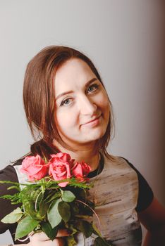 portrait of young charming girl with a bouquet of roses Valentine's Day
