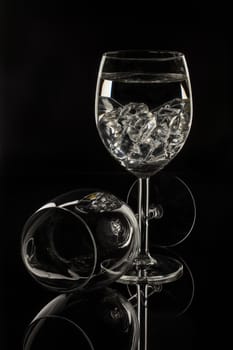 Wineglasses on glass reflecting background