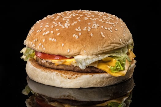 Hamburger on a black reflecting glass studio background