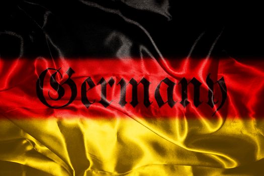 German flag blowing in the wind With Germany Written On It In Gothic Letters