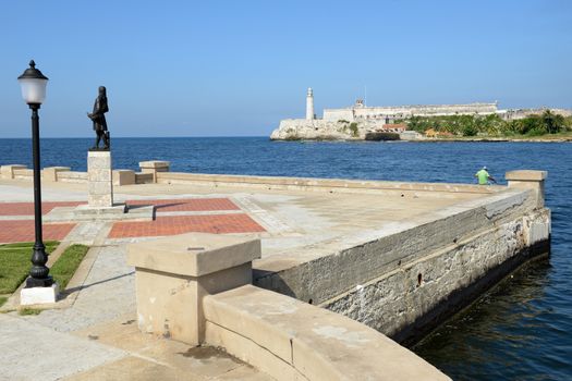 Romantic park in Havana with a view of the castle and lighthouse of El Morro at the bay entrance
