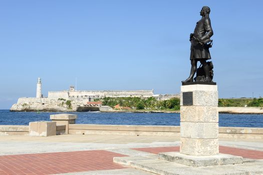 Romantic park in Havana with a view of the castle and lighthouse of El Morro at the bay entrance