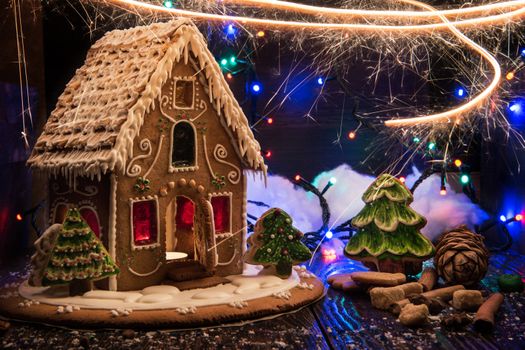 Gingerbread house with lights on dark background, xmas theme