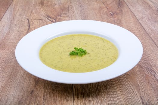 Cream of broccoli soup on a white plate