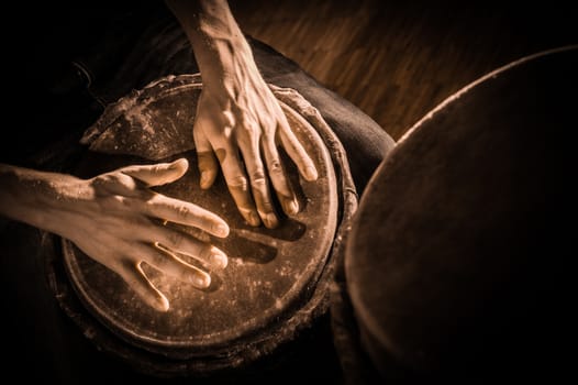 People hands playing music at djembe drums, France