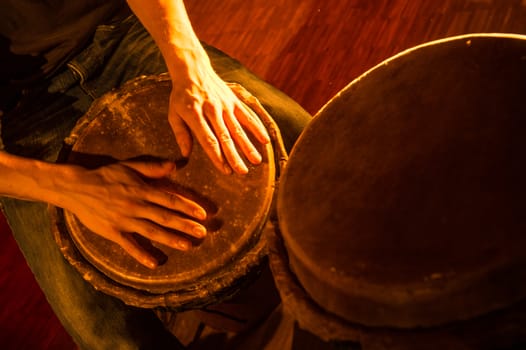 People hands playing music at djembe drums, France