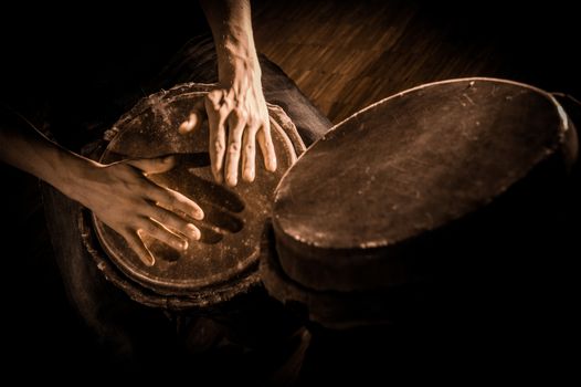 People hands playing music at djembe drums, France
