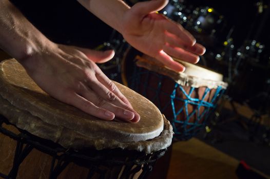 People hands playing music at djembe drums, France