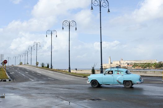 Havana, Cuba - 27 January 2016: Person driving his vintage car at the Malecon in Havana on Cuba