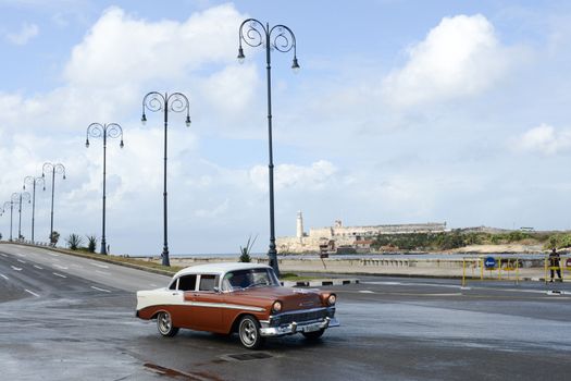 Havana, Cuba - 27 January 2016: Person driving his vintage car at the Malecon in Havana on Cuba