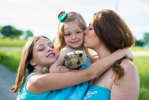 mother and two daughters in the garden