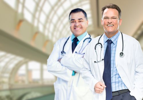 Handsome Male Doctors or Nurses Standing Inside Hospital Building.