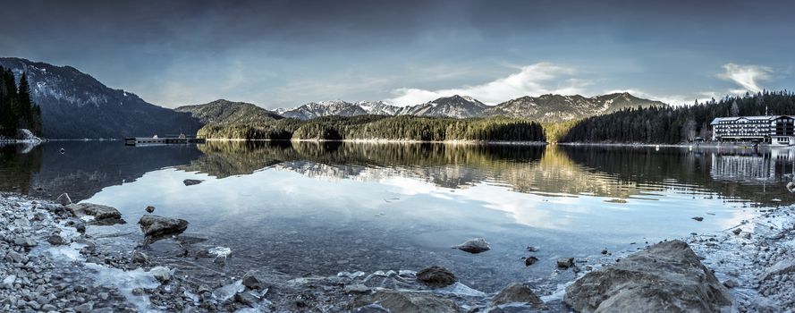 Panorama image with the lake Eibsee and its icy shore, near the municipality Grainau, in the district of Garmisch-Partenkirchen, in Bavaria, Germany