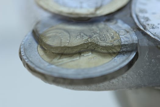 Two Euro coin in ice, frozen assets