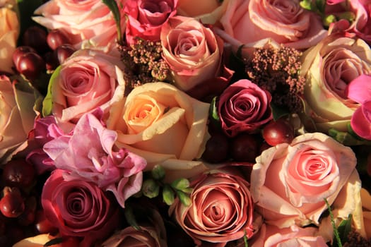 Pastel roses in different shades of pink in a bridal arrangement