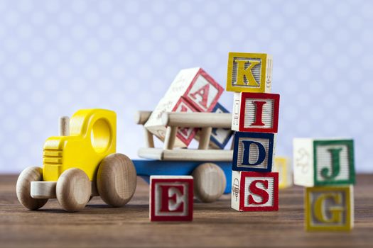 Children's World toy on a wooden background. Studio shot]